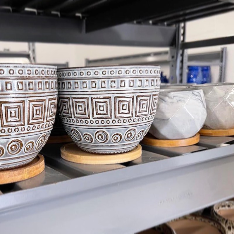 image of white ceramic pots displayed on a shelf.